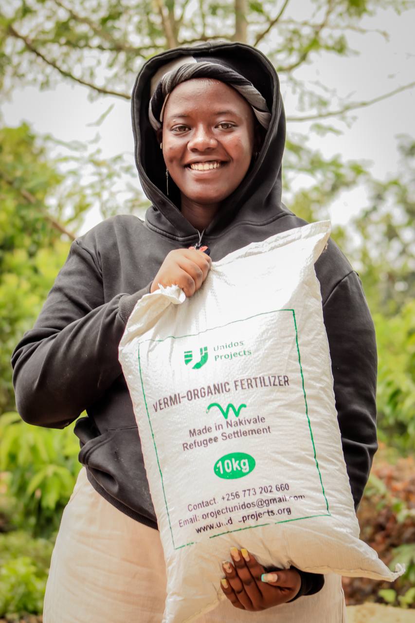 Unidos community member with organic fertilizer
